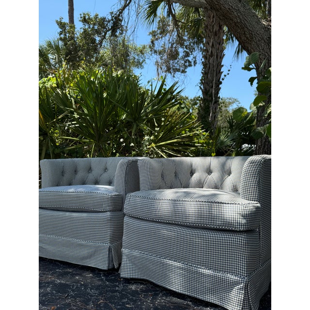A fabulous pair of vintage upholstered club chairs featuring a classic blue and white houndstooth pattern, deep button...
