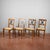 A charming set of four wooden chairs, dating from the late 19th or early 20th century, recalling the classical or...