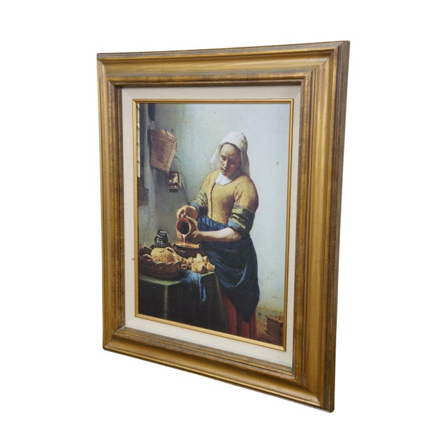 Vintage print on board depicting "The Kitchen-Maid" (The Milkmaid) by Johannes Vermeer. Depicts a serving woman pouring...