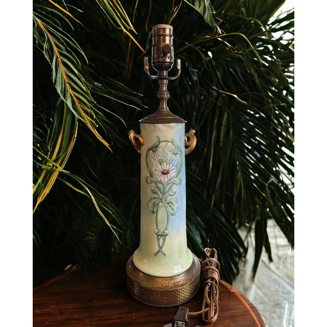 Illuminate your space with the soft charm of this beautifully artisan crafted porcelain lamp. Adorned with delicate floral...