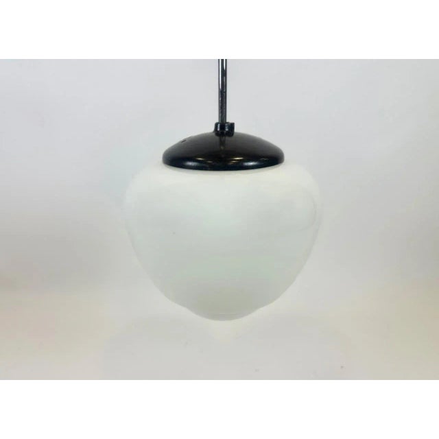 Czech White Milk Glass and Bakelite Pendant Lamp from Napako, 1940s, in Restored conditions. Designed 1920 to 1949 This...