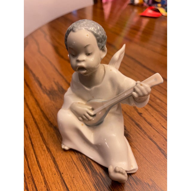 Lladro angel playing the mandolin (hand made in Spain). The angel sat on my grandmother's bedside table.
