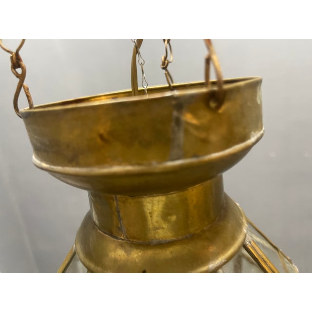 Elegant brass and glass lantern dating from the 1950s, featuring a classic geometric form with finely detailed textured...