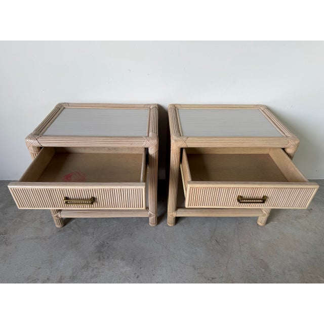 Bring timeless coastal elegance to your bedroom with this beautiful pair of vintage rattan nightstands. Featuring a finely...