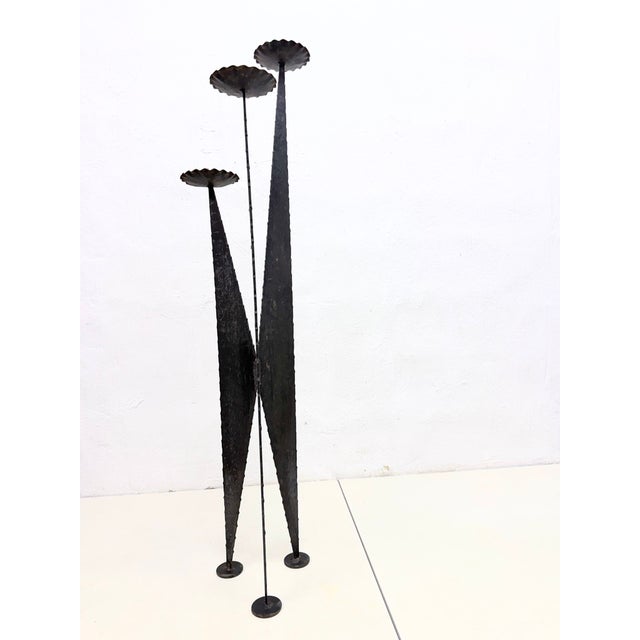 Large triple candlestick from the 1970s. Unmarked. Iron. Good used condition. Some rust. 114 x 28 cm