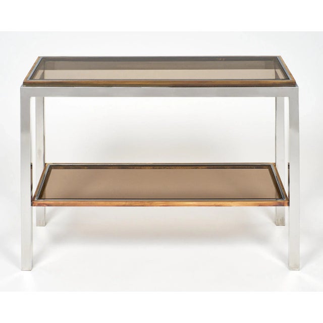 Rare Willy Rizzo console table. This Italian chromed steel two tier console has brass trim and features tinted glass top...