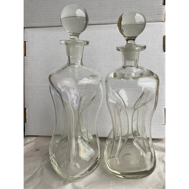 Pair of decanters by Holmegaard in their Kluk pattern. Made of handblown glass, no two are exactly alike.