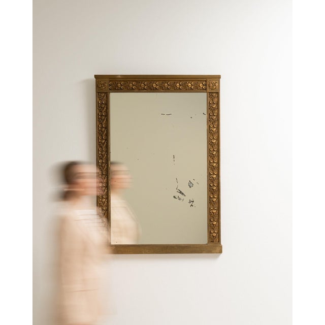 Here is a mirror, its gold gilt textured frame, rectangular the first thing to catch the eye. It was made in France during...