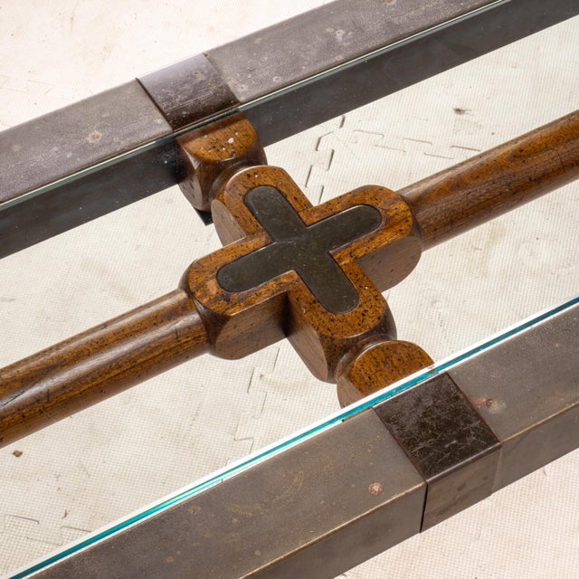 This vintage Brutalist console table features a substantial patinated iron frame paired with a thick beveled glass top and...