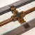 This vintage Brutalist console table features a substantial patinated iron frame paired with a thick beveled glass top and...