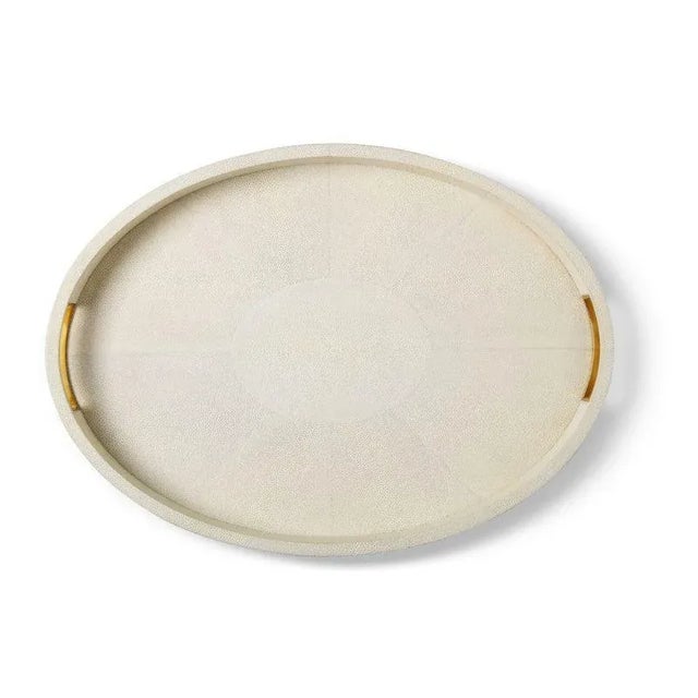 This stylish oval tray has a luxurious Faux Shagreen finish and integrated brass handles, which do not distract from the...