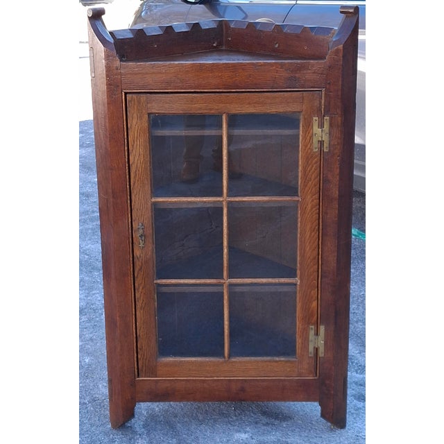 A 19th Century Victorian Oak Corner Cabinet with Glass front door. Functional key present. Measures 30" in width, 17" in...