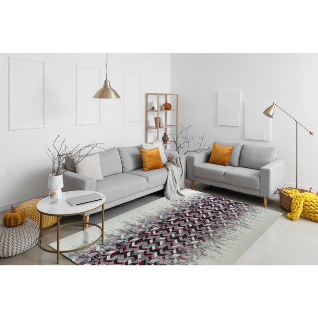 This hand knotted pile rug features a multicolor jewel tone palette and is crafted from 100% wool. It incorporates a Kilim...