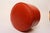 Mid-Century American Modern orange vinyl ottoman (ca. 1960s). Though intended for ottoman/footstool use, doubles as an...