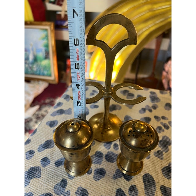 Up for consideration is a beautiful vintage pair of brass salt and pepper shakers with holder. This would look lovely in...