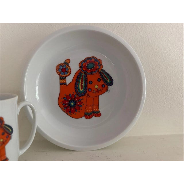 The Bright and Fun Orange Dog Plate and Cup by Spal In Portugal is a charming set featuring a festive orange color and a...