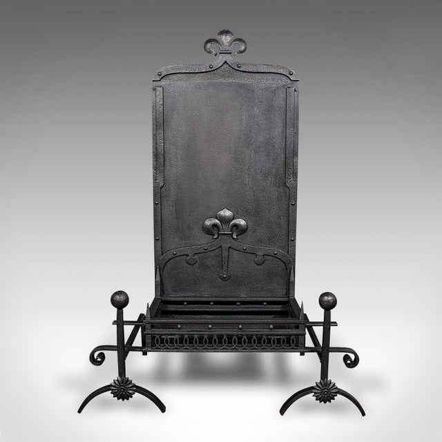This is an antique open hearth fireplace. An English, cast iron high-back fire basket and a pair of andirons, dating to...