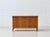 This elegant 1950s sideboard impresses with its clean, mid-century design and harmonious proportions. The warm wood finish...