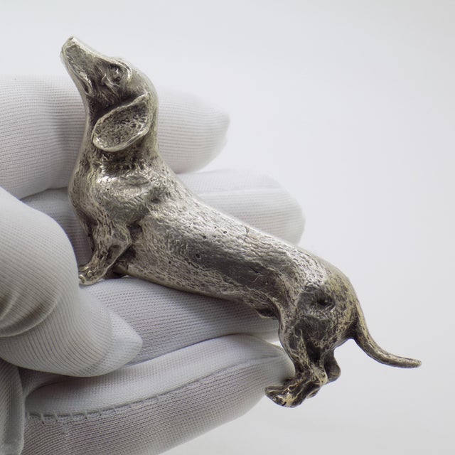 A vintage sculpture of strong presence and striking realism depicting a dachshund, handmade in Italy between the 1950s and...