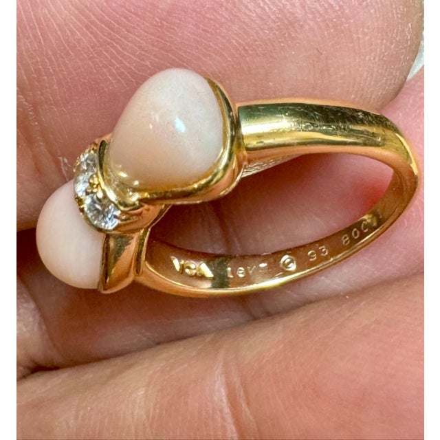 VAN CLEEF & ARPELS A Van Cleef & Arpels Coral Bow and Diamond Ring made in 18 Karat Yellow Gold. The total weight of the...