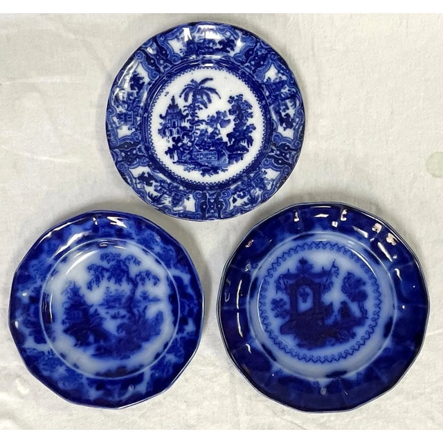 Pretty set of three coordinating decorative plates with Asian inspired designs. Each has a different stamp on the back,...