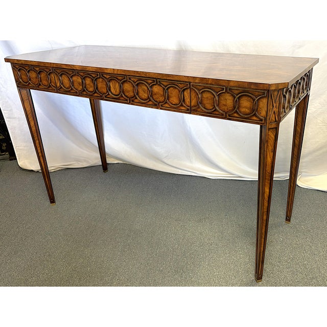 Stylish Theodore Alexander console table from the late 20th century. The piece is beautifully crafted of mahogany and...