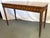 Stylish Theodore Alexander console table from the late 20th century. The piece is beautifully crafted of mahogany and...