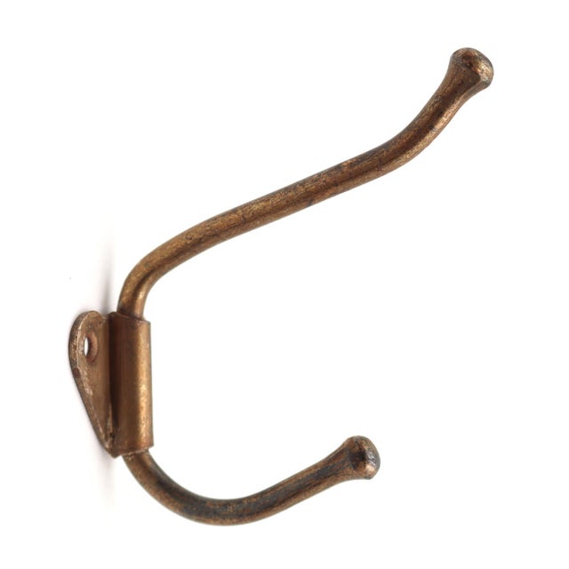 Vintage steel double arm wall hook with a brass finish. The original mounting screws are not available. Good condition...