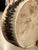 A distinctive pair of round cowhide decorative drums featuring natural cream and tan coloring, textured hair-on-hide...