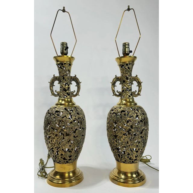 Beautifully detailed pair of heavy vintage brass reticulated filigree lamps. Each measures 32.5"H from base to finial....