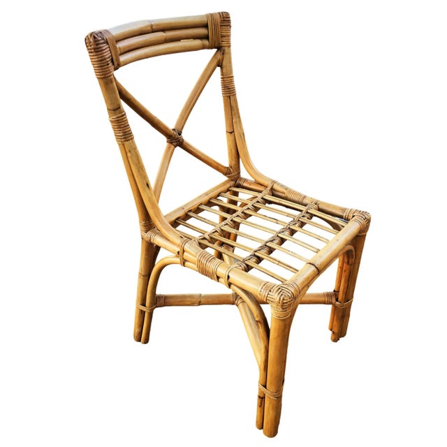 A set of four restored rattan "X" back dining chairs featuring a charming blend of functionality and style. The set...