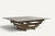 Elegant vintage coffee table from the 1970s, characterized by a striking geometric construction in brushed metal and a...