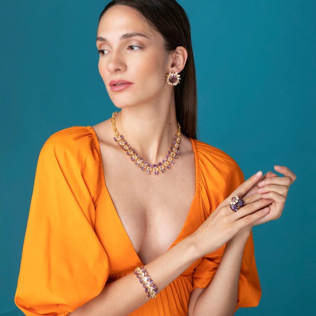 A stunning fusion of Art Deco elegance and metropolitan flair, the Isabella Studs feature a bold round centerpiece framed...