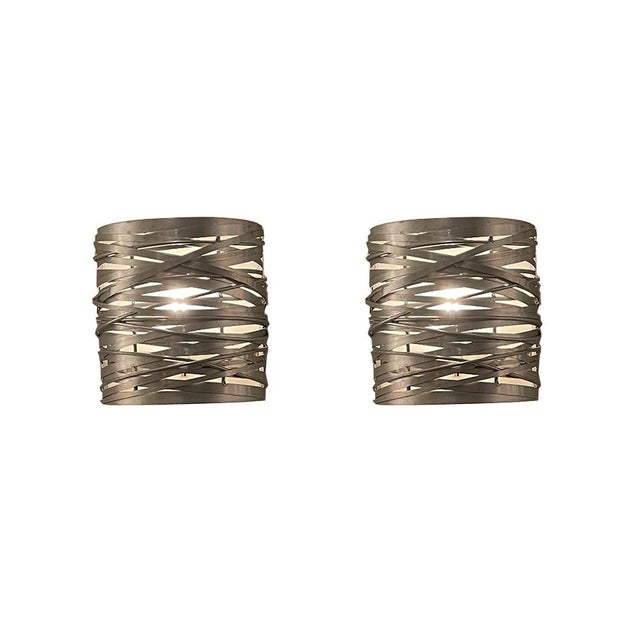 This pair of wall sconces is made of aluminum and measures 10 inches tall, 9.5 inches wide, and protrudes 6 inches from...