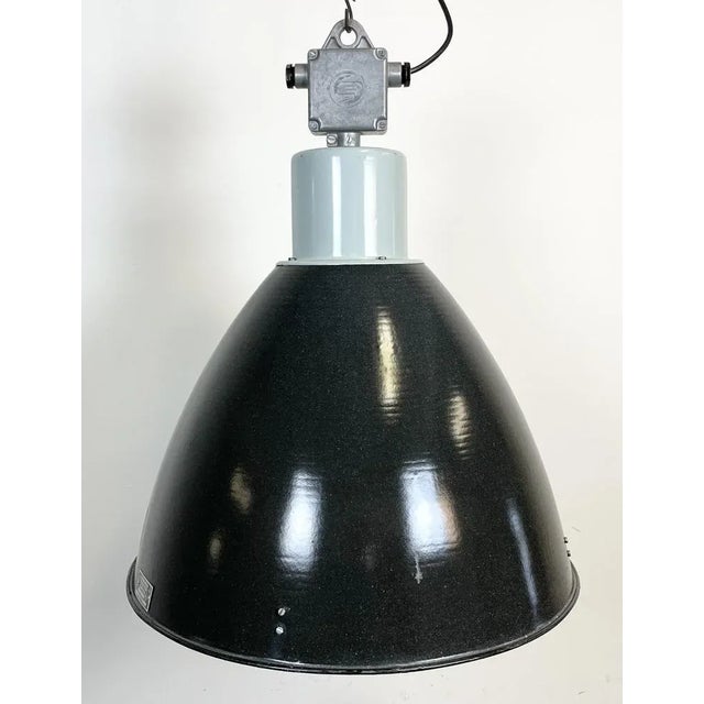 Industrial enamel pendant lamp designed and produced by Elektrosvit in former Czechoslovakia during the 1960s. It features...