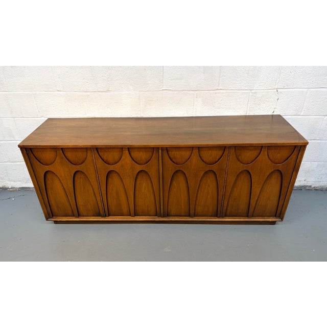 Iconic and highly sought after, this Broyhill “Brasilia” Mid-Century Modern credenza is a true statement piece, celebrated...