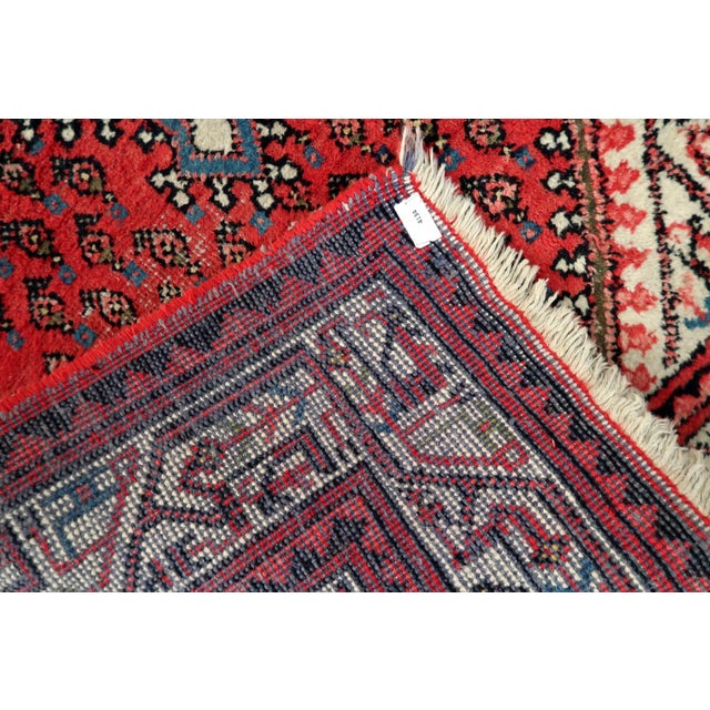 A charming and sophisticated vintage hand-knotted rug from India, crafted in the 1960s. This piece follows the elegant...