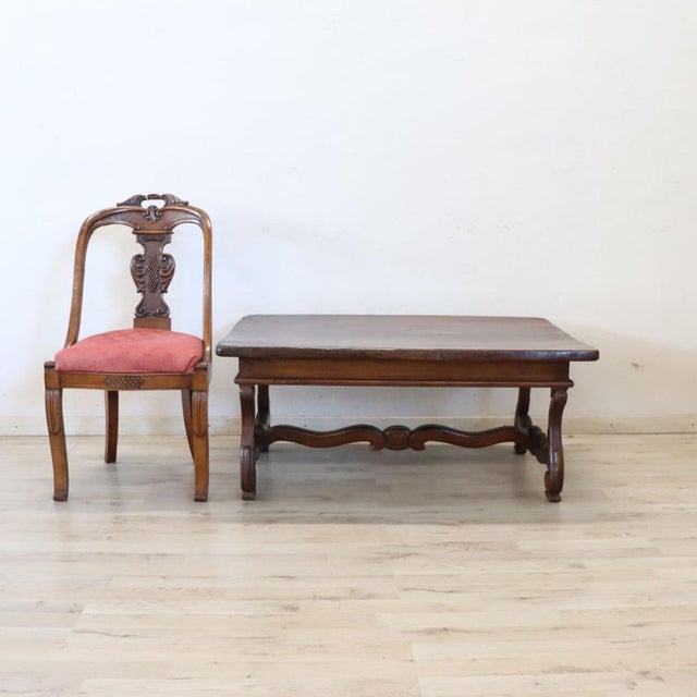 This unique Italian coffee table from the early 20th century, crafted from solid walnut. This coffee table is inspired by...