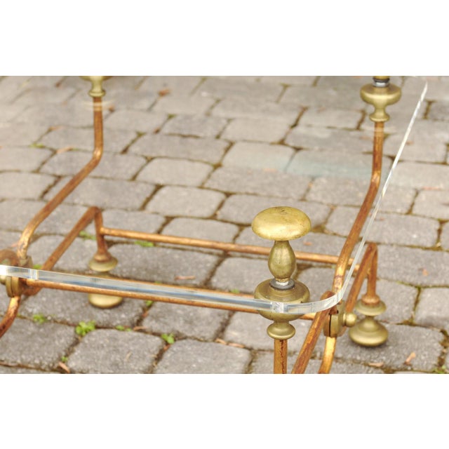 An Italian vintage brass cocktail table from the mid-20th century, with Lucite top. Created in Italy during the mid-20th...
