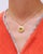 Art Nouveau July locket pendant in 18 karats gold. A circular photo locket centered with an orange glass cabochon,...