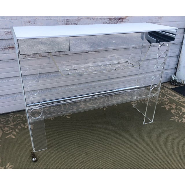 Mid Century white chrome Lucite Bar measures 53.5” W x 17.5” D x 40.5” H. Made in early 20th Century.
