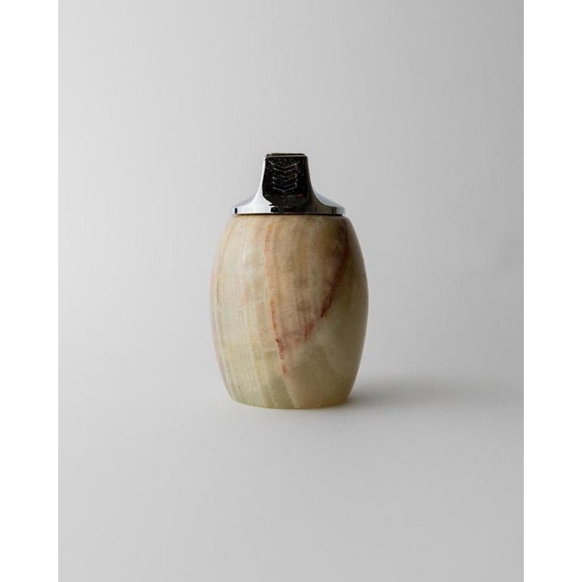 This vintage alabaster table lighter from the 1960s by Piezo, Italy is a refined mid-century design object crafted from...