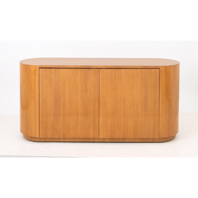 J. Robert Scott "Racetrack" Cabinet, lacquered wood &nbsp;with two doors opening to six shelves. 33" H x 72" W x 21" D....