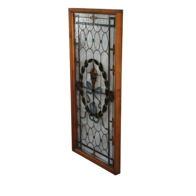 Rare and exceptional antique leaded stained glass window. Features a French Neoclassical ribboned motif with Olympic Torch...