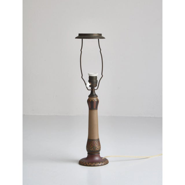 This is an elegant Art Nouveau earthenware table lamp hand painted with abstract motifs. This piece is attributed to the...