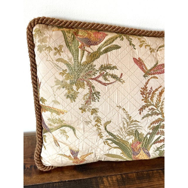 Lovely 1990s lumbar pillow decorated with birds, botanicals, and a damselfly. Rope trim surround with complimentary...