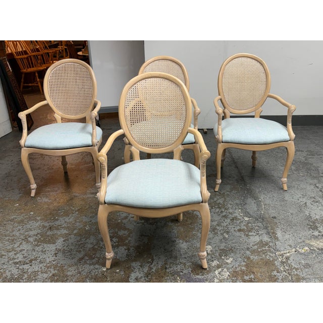 Design Plus Gallery presents a set of four French Louis XVI Style Cane-Back Armchairs. These chairs showcase oval-shaped...