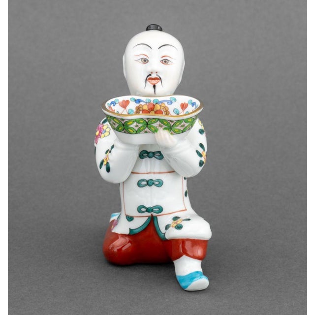 Set of Four Herend Painted Porcelain Figural Open Salts, depicting a Chinese kneeling figure holding floral basket, marked...