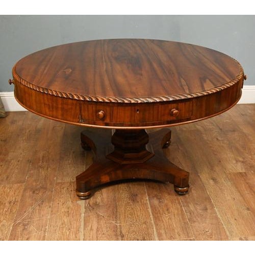 Elegant antique late Regency mahogany drum table featuring a circular top with a beautifully figured mahogany surface and...