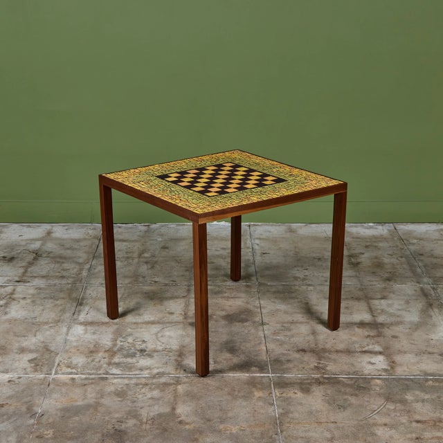 Square game table in the style of Gordon & Jane Martz. The table top is inlaid with yellow ceramic tiles with a...
